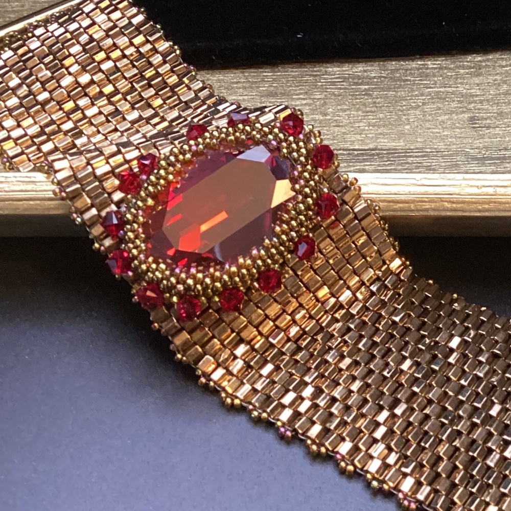 Handmade beaded bracelet. Bronze metallic beads, large bold ruby red Swarovski
